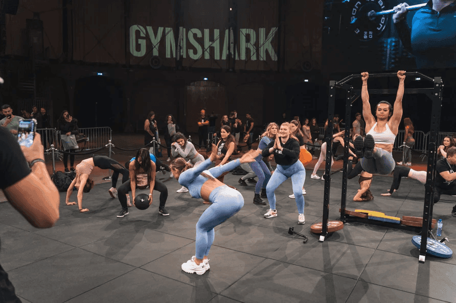 Gymshark building brand community through in-person and virtual fitness events like the Gymshark 66 challenge